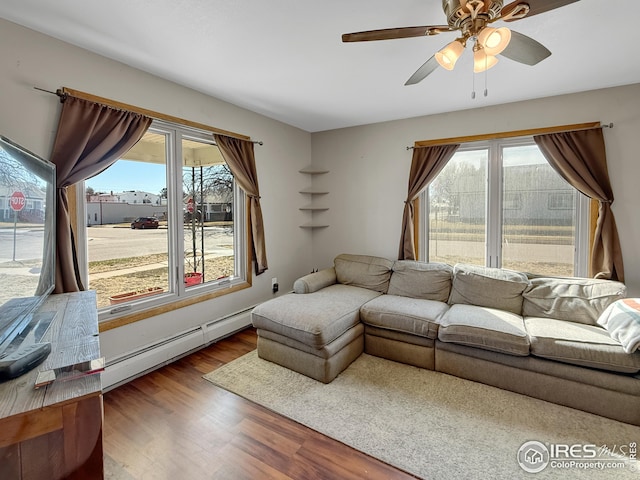 105 N Logan Ave, Haxtun, CO 80731 - living area with a baseboard radiator, wood finished floors, and ceiling fan