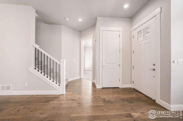 entrance foyer featuring baseboards, recessed lighting, stairway, visible vents, and wood finished floors