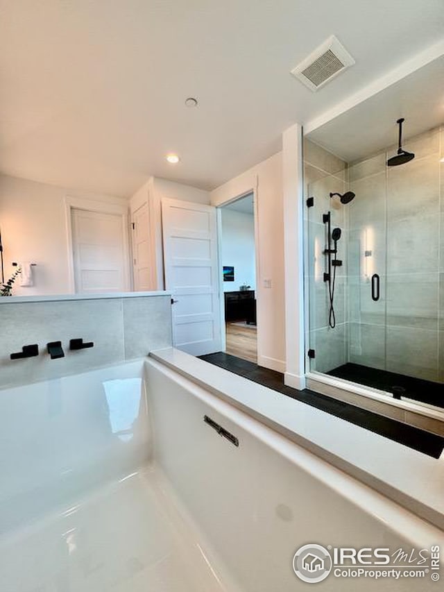bathroom with visible vents, a stall shower, and recessed lighting