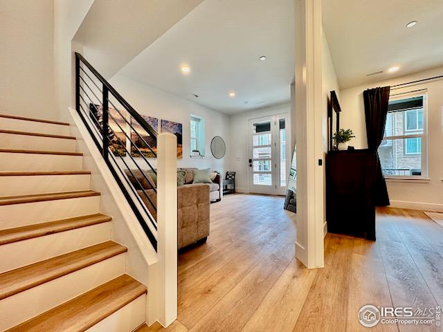 staircase featuring wood-type flooring, baseboards, and recessed lighting