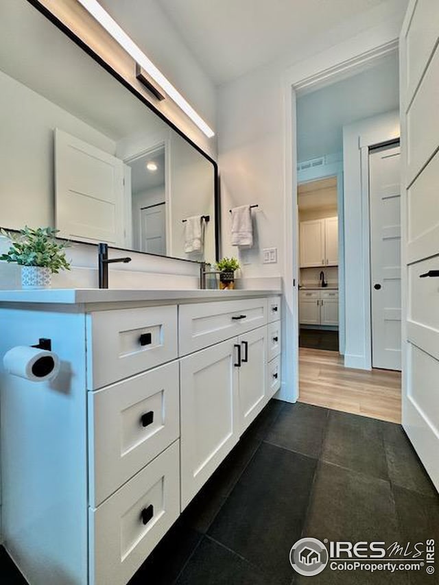 bathroom featuring vanity and wood finished floors