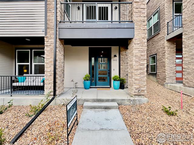 view of exterior entry featuring covered porch