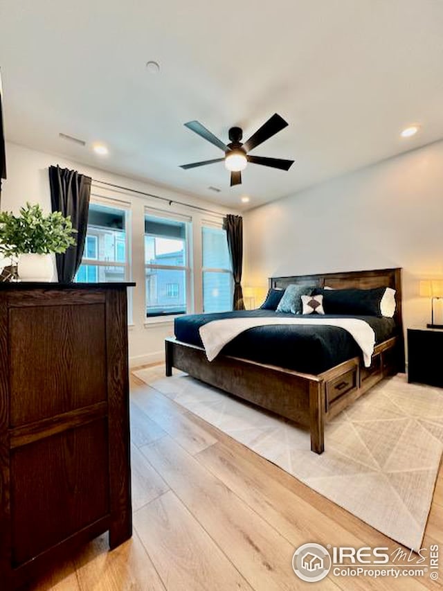 bedroom featuring ceiling fan, light wood finished floors, and recessed lighting