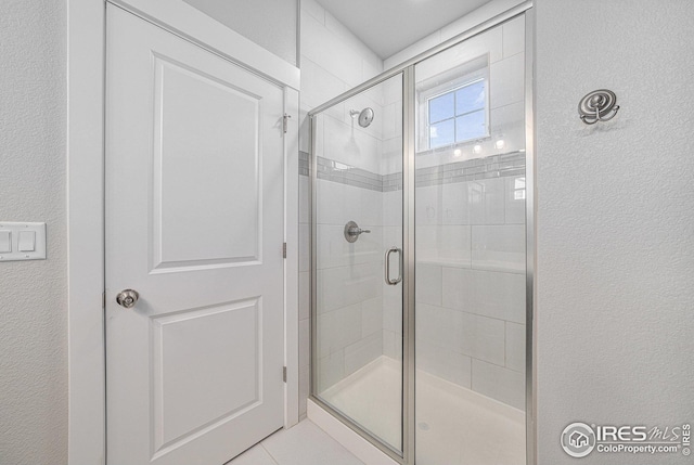 4191 Greenhorn Dr, Loveland, CO 80538 - full bath featuring a shower stall and a textured wall