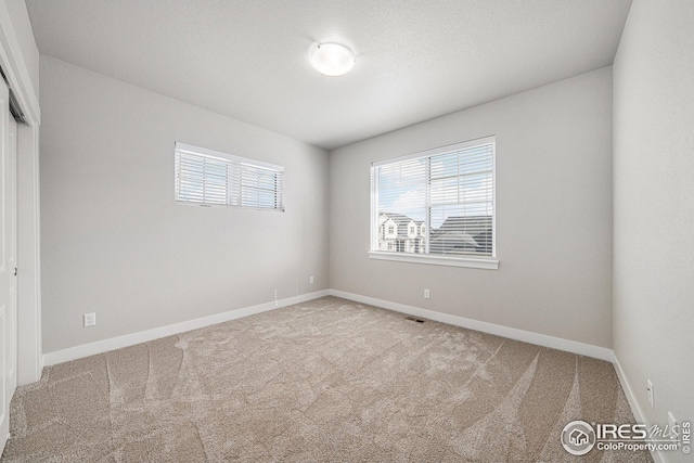 4191 Greenhorn Dr, Loveland, CO 80538 - carpeted empty room with visible vents and baseboards
