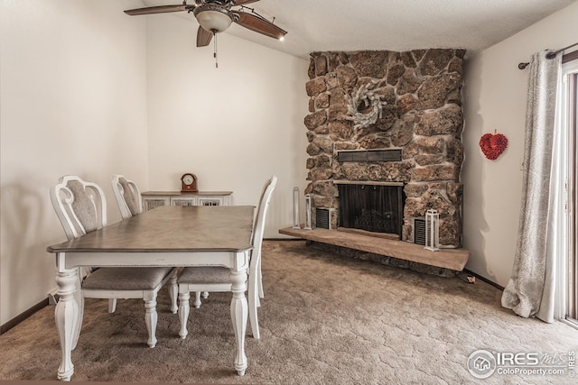 701 43rd Ave, Greeley, CO 80634 - carpeted dining area featuring baseboards, lofted ceiling, a fireplace, and a ceiling fan