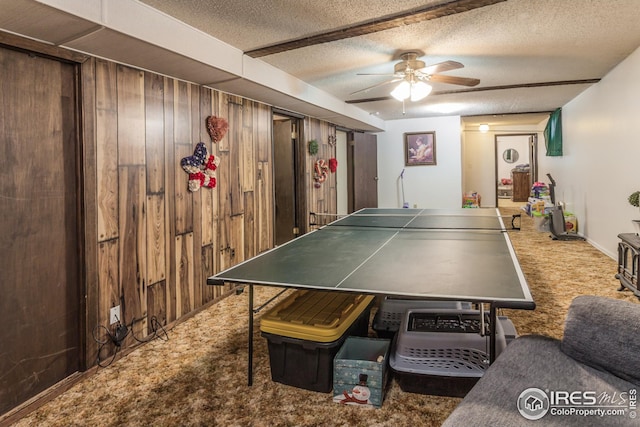 701 43rd Ave, Greeley, CO 80634 - rec room featuring wooden walls, ceiling fan, carpet, and a textured ceiling