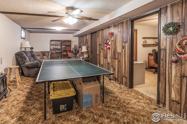 701 43rd Ave, Greeley, CO 80634 - game room featuring a ceiling fan, carpet, wooden walls, and a textured ceiling