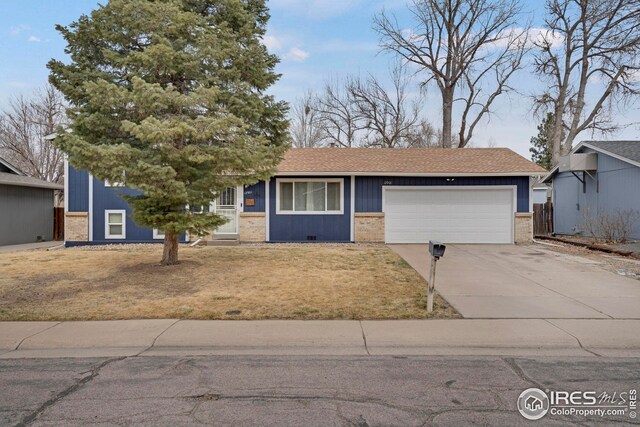 12901 E Idaho Dr, Aurora, CO 80012 - view of front of property with an attached garage, concrete driveway, brick siding, and a front yard