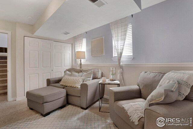 12901 E Idaho Dr, Aurora, CO 80012 - living room with stairs, light colored carpet, and visible vents