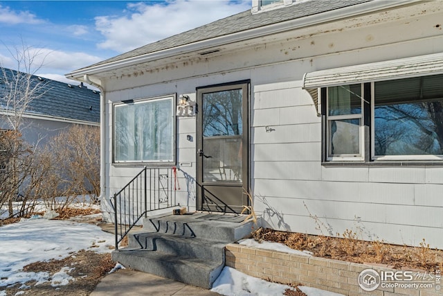 919 State St, Fort Morgan, CO 80701 - snow covered property entrance with roof with shingles