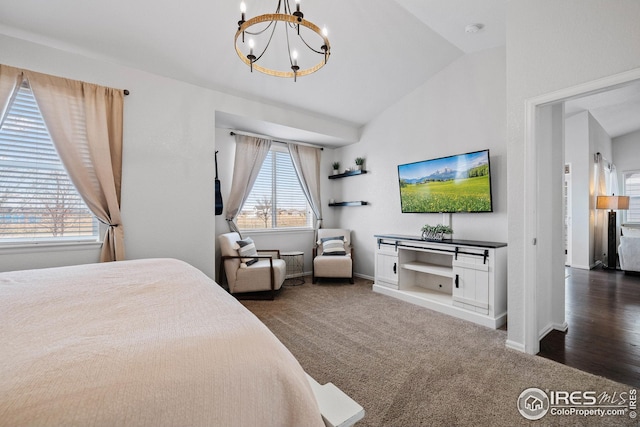 bedroom featuring baseboards, vaulted ceiling, a chandelier, and carpet