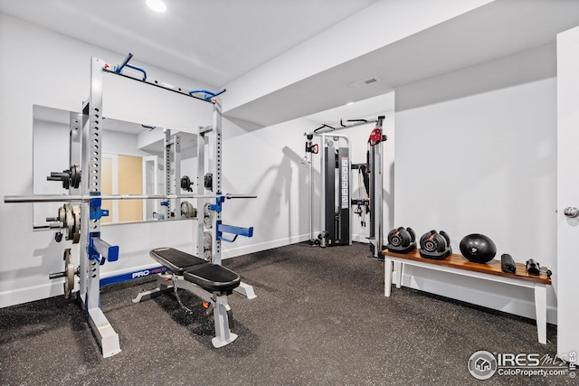 workout room featuring baseboards and visible vents