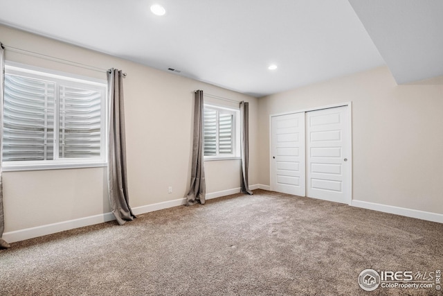 unfurnished bedroom with baseboards, carpet floors, a closet, and recessed lighting