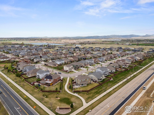 birds eye view of property featuring a residential view and a water and mountain view