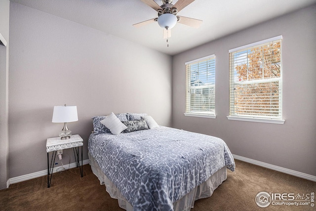 carpeted bedroom with baseboards and ceiling fan