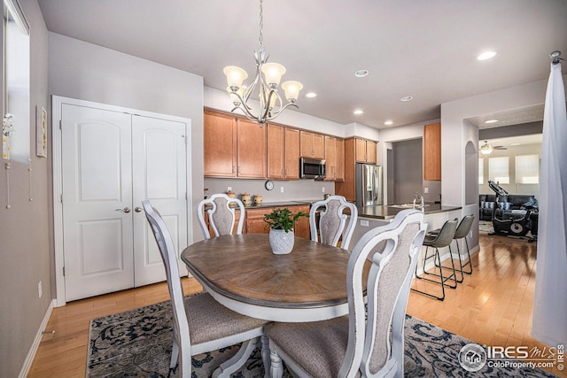 dining room with ceiling fan with notable chandelier, baseboards, light wood-style floors, and recessed lighting