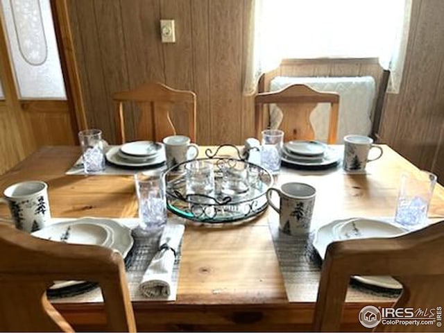 dining space with wood walls