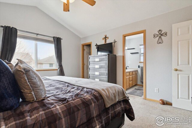 1725 67th Ave, Greeley, CO 80634 - bedroom with baseboards, connected bathroom, light carpet, a sink, and vaulted ceiling