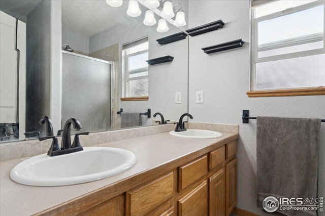 1725 67th Ave, Greeley, CO 80634 - bathroom with double vanity, a sink, and a stall shower