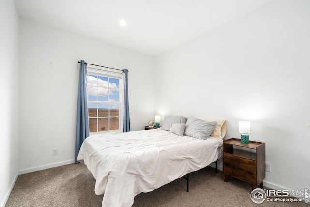 bedroom featuring carpet and baseboards