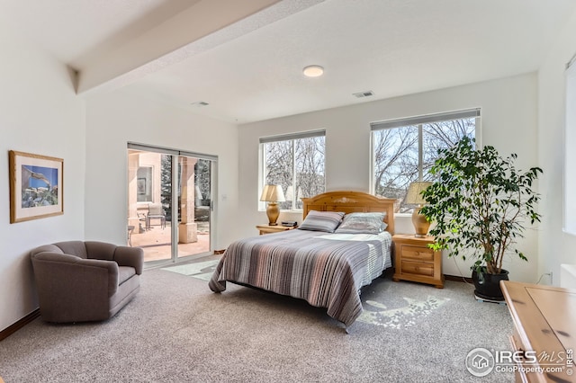 carpeted bedroom featuring baseboards, access to exterior, and visible vents
