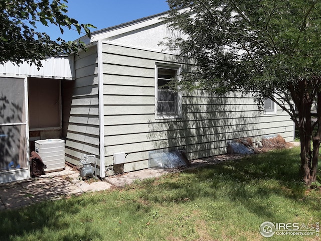 view of property exterior with a lawn