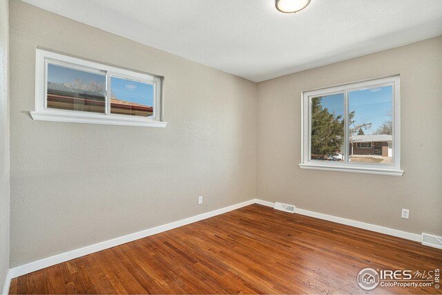 191 Emerald St, Broomfield, CO 80020 - unfurnished room featuring baseboards, visible vents, and wood finished floors
