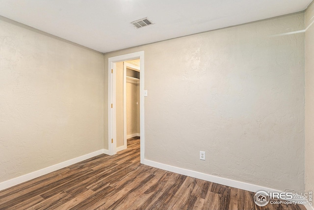 191 Emerald St, Broomfield, CO 80020 - spare room featuring dark wood finished floors, baseboards, visible vents, and a textured wall