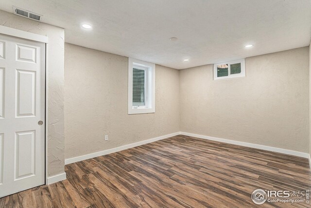 191 Emerald St, Broomfield, CO 80020 - basement featuring baseboards, visible vents, wood finished floors, and a textured wall