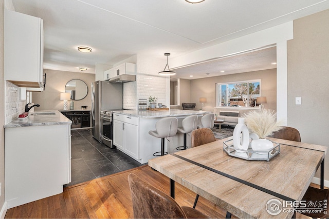 191 Emerald St, Broomfield, CO 80020 - kitchen featuring white cabinetry, electric stove, a sink, and tasteful backsplash