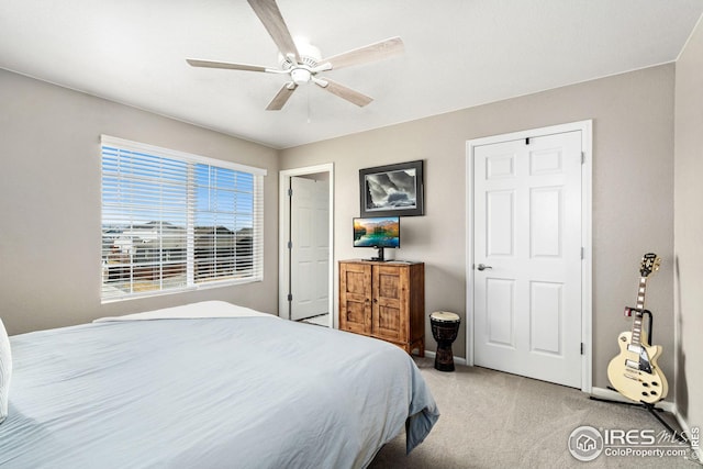 bedroom featuring baseboards, light colored carpet, and ceiling fan