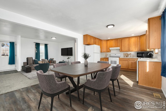 dining room with dark wood-style flooring