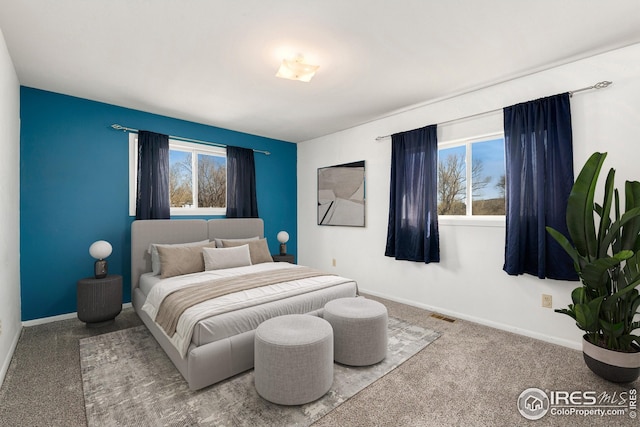 bedroom featuring carpet floors and baseboards