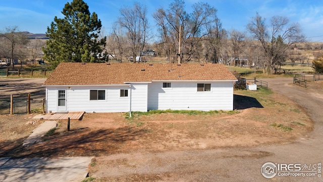 rear view of house with fence