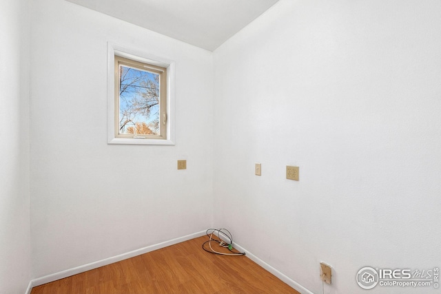 washroom featuring baseboards and wood finished floors