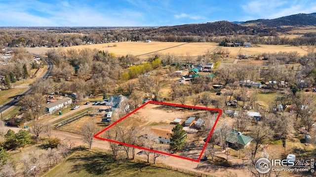 view of rural area with property boundaries highlighted and a mountain backdrop