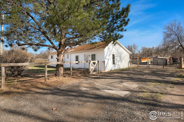 view of home's exterior with a gate and fence