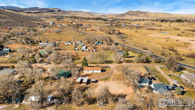 aerial view of property's location featuring a mountain backdrop and rural landscape