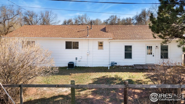 back of property with roof with shingles