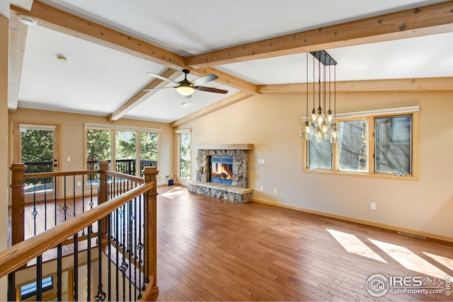 1132 Fairway Club Ln Unit 2, Estes Park, CO 80517 - living room featuring baseboards, ceiling fan, wood-type flooring, and a stone fireplace