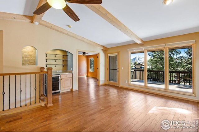 1132 Fairway Club Ln Unit 2, Estes Park, CO 80517 - unfurnished living room with beverage cooler, ceiling fan, light wood finished floors, and baseboards