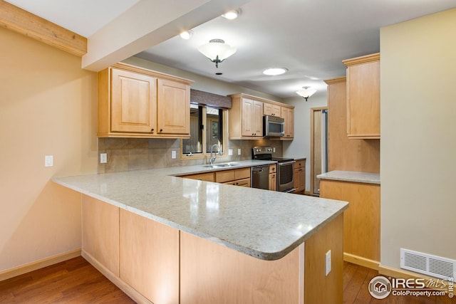 1132 Fairway Club Ln Unit 2, Estes Park, CO 80517 - kitchen featuring appliances with stainless steel finishes, a sink, a peninsula, backsplash, and light brown cabinetry