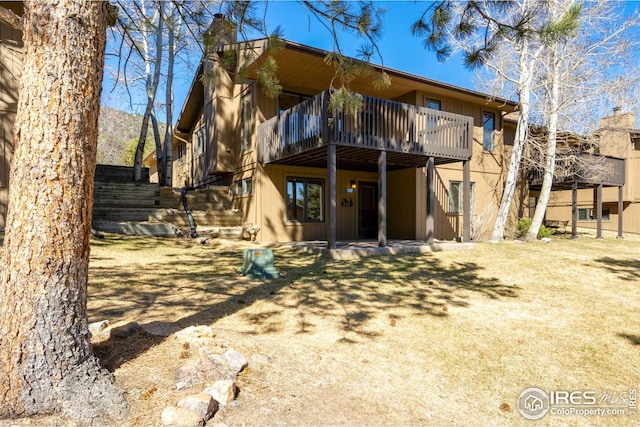 1132 Fairway Club Ln Unit 2, Estes Park, CO 80517 - rear view of property with a chimney and a wooden deck