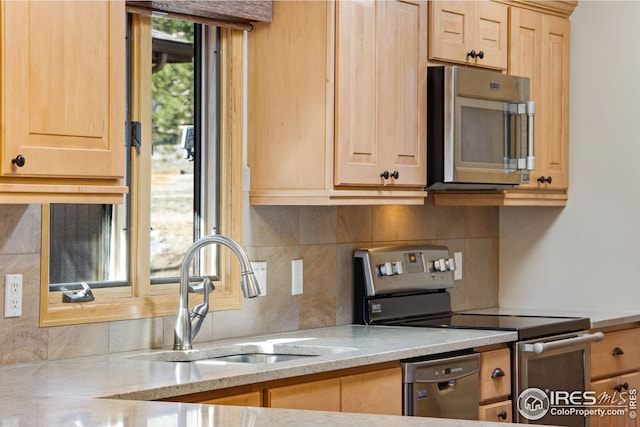 1132 Fairway Club Ln Unit 2, Estes Park, CO 80517 - kitchen with appliances with stainless steel finishes, a sink, light brown cabinets, decorative backsplash, and light stone countertops