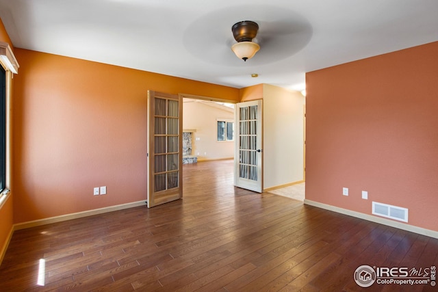 1132 Fairway Club Ln Unit 2, Estes Park, CO 80517 - unfurnished room with wood-type flooring, french doors, and baseboards