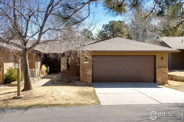 1132 Fairway Club Ln Unit 2, Estes Park, CO 80517 - single story home with stone siding, a garage, driveway, and roof with shingles