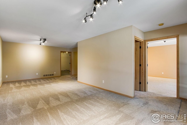 1132 Fairway Club Ln Unit 2, Estes Park, CO 80517 - empty room featuring carpet flooring, track lighting, baseboards, and a smoke detector