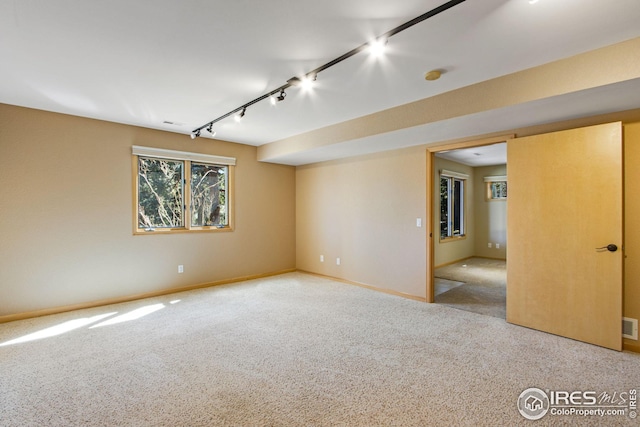 1132 Fairway Club Ln Unit 2, Estes Park, CO 80517 - spare room featuring rail lighting, carpet, and baseboards
