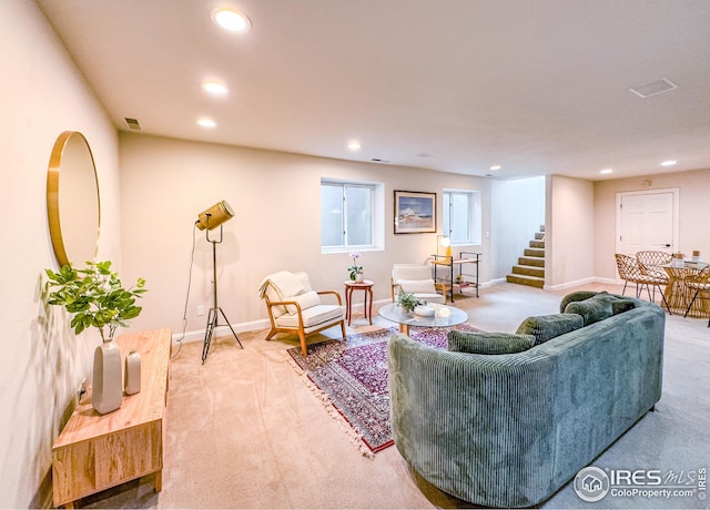 carpeted living area with recessed lighting, stairway, and baseboards